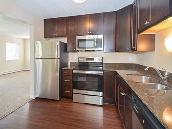 Well-appointed kitchens with granite countertops & stainless steel appliances